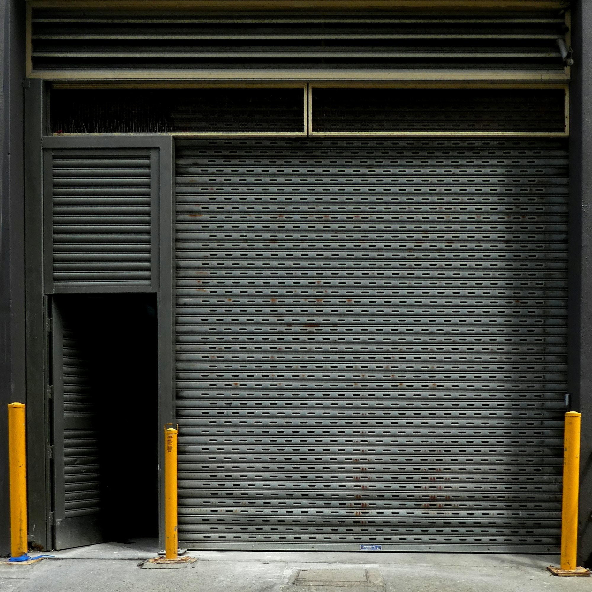 Grey garage door corrugated metal roller shutter